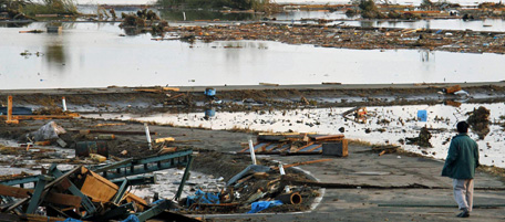 A man looks over the area submerged in water from tsunami in Soma, Fukushima Prefecture, Saturday morning, March 12, 2011 after Japan's biggest recorded earthquake slammed into its eastern coast Friday. (AP Photo/Kyodo News) MANDATORY CREDIT, NO LICENSING ALLOWED IN CHINA, HONG KONG, JAPAN, SOUTH KOREA AND FRANCE