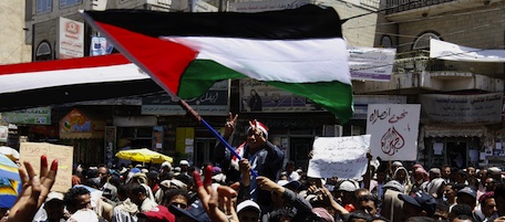 Yemeni anti-government protesters wave their national flag along with the Palestinian flag during a demonstration against President Ali Abdullah Saleh on March 24, 2011 in Sanaa, as Yemen's embattled president, who has ruled the country for the past three decades, warned that a split within the armed forces could lead to civil war. AFP PHOTO / AHMAD GHARABLI (Photo credit should read AHMAD GHARABLI/AFP/Getty Images)