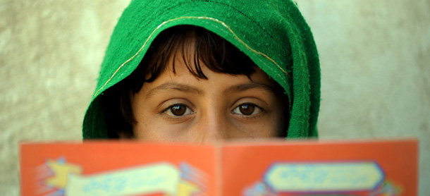 In this picture taken on March 13 an Afghan child holds a book donated by charity in Garmser, Helmand Province, Afghanistan. An emotional Afghan President Hamid Karzai on March 12 told international troops to "stop their operations in our land", his strongest remarks yet over mistaken killings of civilians. A UN report recorded 2,777 civilian deaths last year, underscoring the level of violence in the country as foreign troops prepare to start handing control of security to Afghan forces in some areas from July. AFP PHOTO / ADEK BERRY (Photo credit should read ADEK BERRY/AFP/Getty Images)