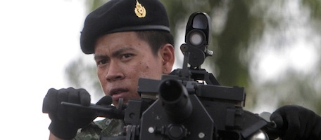 Thai soldiers stand on truck mounted grenade launcher patrol during the fighting between Thai and Cambodia in Surin province, northeastern Thailand,, Thursday, April 28, 2011.Artillery fire boomed across the Thai-Cambodian frontier for a seventh day Thursday as fierce border clashes erupted again between the two neighbors. (AP Photo/Sakchai Lalit)