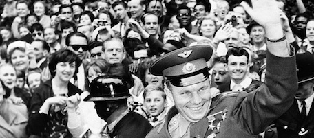 ** ADVANCE FOR USE SUNDAY, APRIL 10, 2011 AND THEREAFTER ** FILE - In this July 15, 1961 picture, cosmonaut Yuri Gagarin, stands in an open car outside the Russian embassy in London and waves to the crowd as he departs for home. It was the Soviet Union's own giant leap for mankind _ one that would spur a humiliated America to race for the moon. It happened on Tuesday, April 12, 1961 when the air force pilot became the first human in space. (AP Photo/File)
