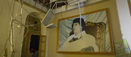 In this photo made on a government organized tour, a portrait of Moammar Gadhafi is seen inside damaged official building following an airstrike in Tripoli, Libya, early Saturday, April 30, 2011.(AP Photo/Darko Bandic)