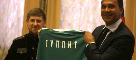 Dutch soccer coach Ruud Gullit, right, shows a shirt reading Gullit in Cyrillic, as he meets with Chechen leader Ramzan Kadyrov, left, in Chechnya's provincial capital, Grozny, Russia, Wednesday, Feb. 9, 2011. Gullit is to take over as coach of Russian league club Terek Grozny. but has has been criticized at home for his his decision to accept an 18-month contract to coach the club despite the human rights record of Kadyrov, who is also president of the club. (AP Photo/Musa Sadulayev)