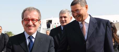 Tunisian new Interior Minister Habib Essid (R) greets his Italian counterpart Roberto Maroni (L) upon arrival, on April 5, 2011 in Tunis. Italy's Prime Minister Silvio Berlusconi announced on the eve, the creation of a binational commission with Tunisia in a bid to halt the immigration wave from the north African state. AFP PHOTO FETHI BELAID (Photo credit should read FETHI BELAID/AFP/Getty Images)