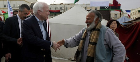 US Rebuplican senator John McCain (L) shakes hands with a Libyan rebel during his tour to the rebel headquarters in their eastern stronghold city of Benghazi on April 22, 2011. McCain is the highest-ranking US politician to visit Libya's rebel-held east since a popular uprising began against Moamer Kadhafi's rule in mid-February. AFP PHOTO/MARWAN NAAMANI (Photo credit should read MARWAN NAAMANI/AFP/Getty Images)