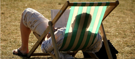 LONDON, ENGLAND - SEPTEMBER 08: A man reads a book in a deckchair as he enjoys the afternoon sunshine in Hyde Park on September 8, 2009 in London, England. Temperatures in the capital reached 27 degrees Celsius today as the South of England enjoys a spell of unseasonally good weather. (Photo by Oli Scarff/Getty Images)