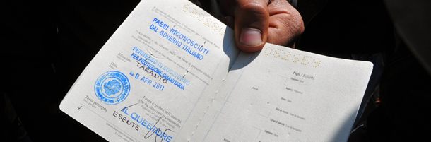 A Tunisian would-be immigrant shows his new residency permit before boarding a train at Rome's Termini station to Ventimiglia, the Italian border town with France on April 21, 2011. Dozens out of the thousands who have fled from Tunisia to Italy by boat in recent weeks in the wake of the Jasmine Revolution in January are arriving in the border town of Ventimiglia every day -- armed with new residency permits. AFP PHOTO / ANDREAS SOLARO (Photo credit should read ANDREAS SOLARO/AFP/Getty Images)