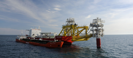 A picture taken on April 9, 2011 shows Caspian Stream tanker near the Russian LUKOIL ice-resistant fixed platform LSP-1, built at the Astrakhansky Korabel shipyard, intended to drill and operate wells and collect and pre-treat reservoir content at Korchagin's oil field in the Russian sector of the Caspian Sea some 180 km outside Astrakhan. The fields productivity of oil and gas condensate will peak at 2.3 million tonnes oil and 1.2 bcm gas per year. AFP PHOTO / MIKHAIL MORDASOV (Photo credit should read MIKHAIL MORDASOV/AFP/Getty Images)