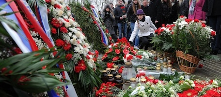 People lay floral tributes as they gather to commemorate the victims of the Smolensk presidential plane crash on the Smolensk airdrome on April 10, 2011. President Lech Kaczynski, his wife Maria and scores of other top Polish political and military officials died when their plane crashed near the western Russian city of Smolensk one year ago. AFP PHOTO / NATALIA KOLESNIKOVA (Photo credit should read NATALIA KOLESNIKOVA/AFP/Getty Images)