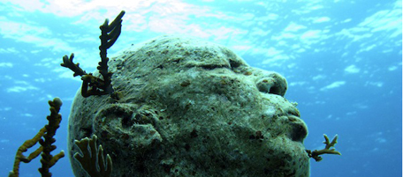 In this photo taken Feb. 19, 2010, coral reef has begun to grow on holes drilled into the Man on Fire sculpture, by british artist Jason de Caires in the waters near Isla Mujeres, Mexico. This sculpture forms part of an underwater sculpture garden still under construction and when completed will form part of the world's largest underwater art museum, according to the artist's website.(AP Photo/Miguel Tovar)