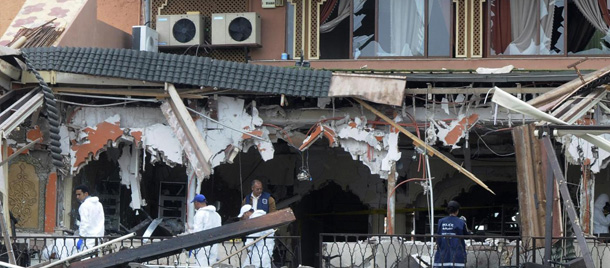 RETRANSMISSION FOR ALTERNATIVE CROP - Police experts work in a damaged building after an explosion ripped through a cafe popular among foreign tourists in the Moroccan city of Marrakech, Morocco, Thursday, April, 28, 2011, killing and wounding people in what the government called a suspected criminal act. If confirmed as terrorism, the blast in the iconic Djemma el-Fna square would be Morocco's deadliest bombing in eight years. (AP Photo/Tarik Najmaoui)