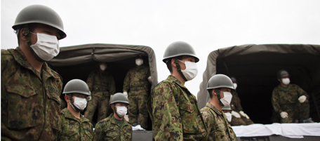 YAMAMOTO, JAPAN - APRIL 08: Japan Self-Defense Force members gather during a mess funeral on April 8, 2011 in Yamamoto, Miyagi Prefecture, Japan. The 9.0 magnitude strong earthquake struck offshore on March 11 at 2:46pm local time, triggering a tsunami wave of up to ten metres which engulfed large parts of north-eastern Japan, and also damaging the Fukushima nuclear plant and threatening a nuclear catastrophe. The death toll continues to rise with numbers of dead and missing exceeding 20,000 in a tragedy not seen since World War II in Japan. (Photo by Athit Perawongmetha/Getty Images)