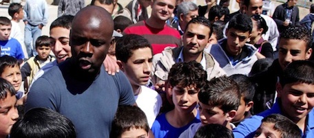 Former French soccer player Lilian Thuram visits a school in the West bank refugee camp of Kalandia, on 11 April 2011. Thuram is visiting the Palestinian territory in support of the education program funded by France through the United Nations Relief and Works Agency (UNRWA)./Credit:ISSAM RIMAWI/APA IMAGES/SIPA/1104111510