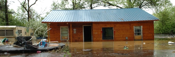 An evacuated home surrouded by flood water from tributaries of the Mississippi River along KY121 near Wickliffe, Ky., is seen Wednesday, April 27, 2011. (AP Photo/The Paducah Sun, Stephen Lance Dennee)