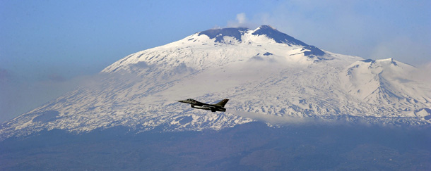One of the six F16 fighter planes from Denmark air force based at the Italian military airport of Sigonella, southern Italy takes off in front of the Vulcano Etna at the base on March 25, 2011. AFP PHOTO / Filippo MONTEFORTE (Photo credit should read FILIPPO MONTEFORTE/AFP/Getty Images)