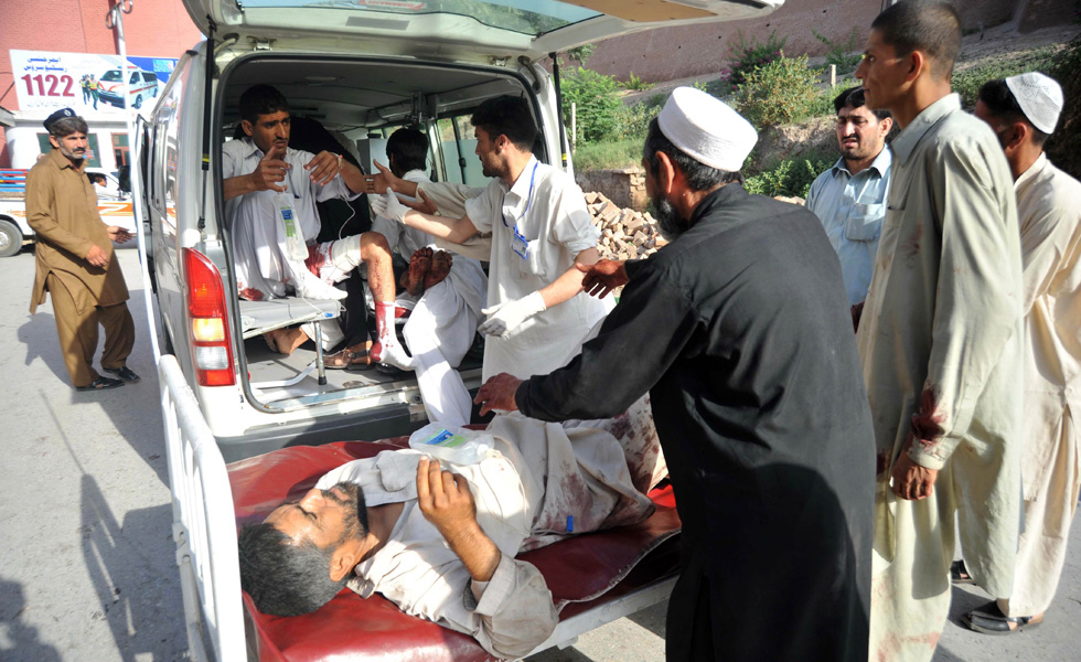 Pakistani paramedics help injured blast victims as they arrive at a hospital in Peshawar on May 13, 2011 following a suicide and bomb attack on the paramilitary police in the northwestern Charsadda district. Seventy people were killed on May 13 when a suicide and bomb attack ripped through a group of Pakistani paramilitary police as they were about to be bussed home on leave from a training centre. It was the deadliest attack in the nuclear-armed Muslim country this year and came with Pakistan's military and civilian leadership plunged into crisis over the killing of Al-Qaeda chief Osama bin Laden by US commandos. AFP PHOTO/ HASHAM AHMED (Photo credit should read HASHAM AHMED/AFP/Getty Images)