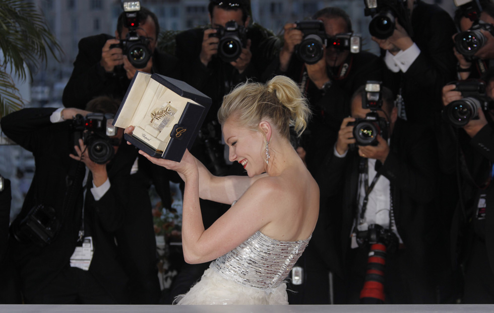 Actress Kirsten Dunst poses with her award for Best Actress for the film Melancholia during the awards photo call at the 64th international film festival, in Cannes, southern France, Sunday, May 22, 2011. (AP Photo/Joel Ryan)