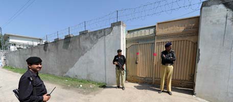Pakistani policemen stand guard at the sealed gate of the building which served as a hideout to Al-Qaeda leader Osama bin Laden following his death by US Special Forces in a ground operation in Abbottabad on May 3, 2011. The bullet-riddled Pakistani villa that hid Osama bin Laden from the world was put under police control, as media sought to glimpse the debris left by the US raid that killed him. Bin Laden's hideout had been kept under tight army control after the dramatic raid by US special forces late May 1 in the affluent suburbs of Abbottabad, a garrison city 50 kilometres (30 miles) north of Islamabad. AFP PHOTO/ AAMIR QURESHI (Photo credit should read AAMIR QURESHI/AFP/Getty Images)