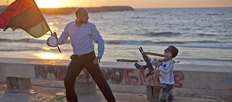 A man plays with his son along the seafront in Benghazi, Libya, Saturday, May 7, 2011. (AP Photo/Rodrigo Abd)