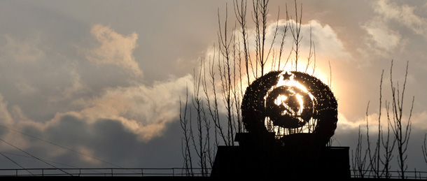 A sculpture depicting the former symbol of the USSR is set against the setting sun in the abandonned city of Pripyat close to Chernobyl on March 31, 2011. The project to build a new sarcophagus over the damaged Chernobyl nuclear reactor lacks some 600 million euros of the 1.5 billion needed, a Ukrainian official said. AFP PHOTO/ SERGEI SUPINSKY (Photo credit should read SERGEI SUPINSKY/AFP/Getty Images)