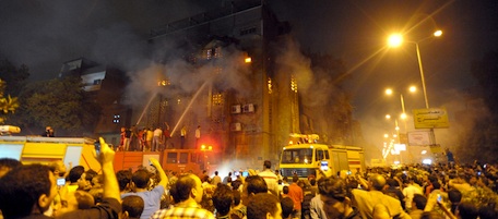 Egyptians gather as firefighters extinguish a fire on a church after clashes between Muslims and Christians in Cairo on May 7, 2011. Clashes between Muslims and Christians in the Egyptian capital left six people dead and about 50 others injured, the health ministry said. AFP PHOTO (Photo credit should read STR/AFP/Getty Images)