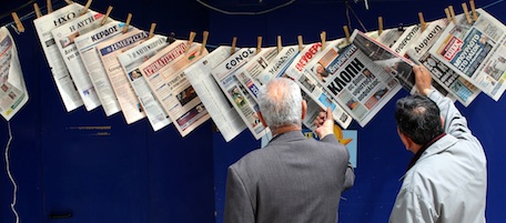 Greeks read newspapers hanging at a kiosk in Piraeus port, near Athens, on Tuesday, May 3, 2011. In the most front pages of newspapers there was reports about the death of al-Qaida's terrorist organization leader Osama Bin Laden the master mind behind the Sept.11, 2001, terror attacks in New York.(AP Photo/Petros Giannakouris)