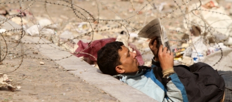 An Egyptian anti-government demonstrator reads a newspaper at Tahrir Square in Cairo on February 6, 2011 on the 13th day of protests calling for the ouster of President Hosni Mubarak. AFP PHOTO/KHALED DESOUKI (Photo credit should read KHALED DESOUKI/AFP/Getty Images)