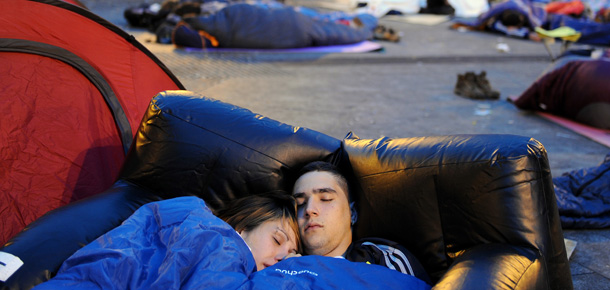 MADRID, SPAIN - MAY 22: Young people camp out at Sol square on the morning that voting in Spain's regional elections begins on May 22, 2011 in Madrid, Spain. Despite a ban on political protests ahead of Spain's regional elections the number of demonstrators, angry with the high youth unemployment and economic policies, gathered in the capital's central Puerta del Sol square has increased to about thirty thousand. (Photo by Jasper Juinen/Getty Images)