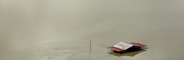 A barn can be seen above the floodwaters of the Mississippi river in Natchez, Miss., Tuesday, May 17, 2011. The Coast Guard said it closed the Mississippi River at the port in Natchez, Miss., on Tuesday because barge traffic could increase pressure on the levees. Heavy flooding from Mississippi tributaries has displaced more than 4,000 in the state, about half of them upstream from Natchez in the Vicksburg area. (AP Photo/Dave Martin)