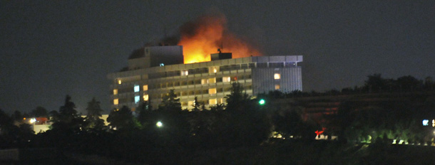 Smoke and flames light up the night from a blaze at the Intercontinental hotel after an attack on the hotel by Taliban fighters and a response by Afghan security forces backed by NATO helicopters in Kabul on June 29, 2011. Taliban suicide bombers and gunmen attacked the hotel popular with foreigners and Afghan officials, sparking a five-hour assault that left several casualties and part of the building in flames. NATO helicopters were called in to help crush the brazen attack, which officials said ended in the early hours of on June 29 with six would-be suicide bombers killed by security forces. AFP PHOTO/Massoud HOSSAINI (Photo credit should read MASSOUD HOSSAINI/AFP/Getty Images)