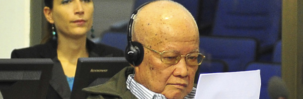 In this photo released by the Extraordinary Chambers in the Courts of Cambodia, Khieu Samphan, former head of state, reads a document paper during the second trial to the top leaders of Khmer Rouge in the court hall of the U.N.-backed war crimes tribunal, on the outskirts of Phnom Penh, Cambodia, Monday, June 27, 2011. Now old and infirm, four of the top surviving members of the Khmer Rouge's ruling elite are about to face justice, decades after their plans for a Communist utopia in Cambodia left an estimated 1.7 million people dead by execution, medical neglect, overwork and starvation. (AP Photo/ Extraordinary Chambers in the Courts of Cambodia, Mark Peters) EDITORIAL USE ONLY