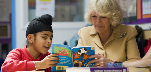 LONDON - JUNE 21: Camila, Duchess of Cornwall, reads with pupil Abhjit Aroia as she visits The Cavendish Primary School to promote the benefits of reading, on June 21, 2011 in Chiswick, West London, England. (Photo by Jeremy Selwyn - WPA Pool/Getty Images)