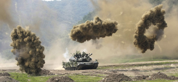 Smoke bombs explode near a South Korean army K-1 tank during a South Korea and U.S. joint military exercise against possible North Korean attacks in Paju, near the demilitarized zone (DMZ) between the two Koreas, on Wednesday, June 8, 2011. North Korea conducted a routine short-range missile test last week in an apparent effort to improve its missile capabilities, a South Korean official said Wednesday, amid renewed tension on the Korean peninsula.(AP Photo/Ahn Young-joon)