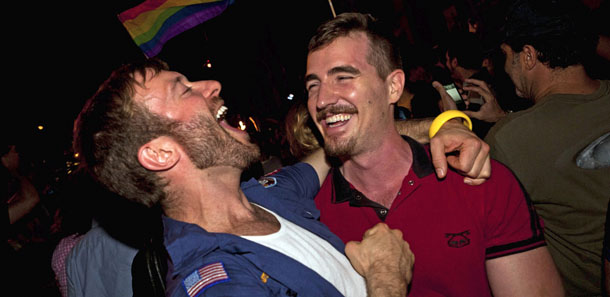 Colin Cunliffe, left, and Brewter Mccall, right, of Manhattan, celebrate the legalization of same-sex marriage in New York State outside the Stonewall Inn on Christopher St, Friday, June 24, 2011, in New York. The measure passed, 33-29, following weeks of tense delays and debate. (AP Photo/John Minchillo)