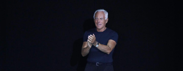 Italian designer Giorgio Armani acknowledges the applause after presenting the Emporio Armani men's Spring-Summer 2012 collection, part of the Milan Fashion Week, in Milan, Italy, Sunday, June 19, 2011. (AP Photo/Antonio Calanni)