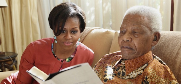 In this photo provided by the Nelson Mandela Foundation on Tuesday, June 21, 2011, US First Lady Michelle Obama, left, with former South African President Nelson Mandela, at this home, in Houghton, South Africa. First lady Michelle Obama and her family met with Nelson Mandela during a private visit at the former South African president's home. Mrs. Obama, daughters Malia and Sasha, and her mother, Marian Robinson, were viewing some of Mandela's personal papers at his foundation Tuesday when according to White House officials, he sent word that he wanted to meet them. It was Mrs. Obama's first meeting with the prisoner-turned-president. (AP Photo/ Debbie Yazbek, Nelson Mandela Foundation) EDITORIAL USE ONLY
