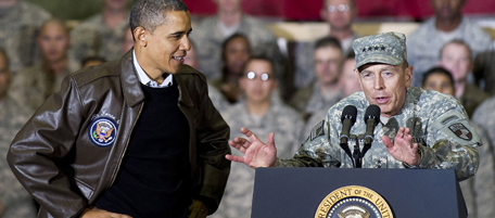 US commander in Afghanistan General David Petraeus (R) introduces US President Barack Obama as he arrives to address troops at Bagram Air Base in Afghanistan December 3, 2010 during a surprise visit for the holidays. AFP PHOTO/Jim WATSON (Photo credit should read JIM WATSON/AFP/Getty Images)