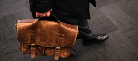 BERKELEY, CA - FEBRUARY 16: A job seeker carries a worn briefcase at the Green Jobs and Entrepeneurship Fair on February 16, 2011 in Berkeley, California. Hundreds of job seekers attended the one day job fair that focused on green jobs. (Photo by Justin Sullivan/Getty Images)