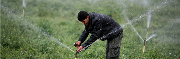 A Palestinian farmer works on his irrigation system supplied by water coming from a large tank (unseen) built by the Palestinian Agricultural Relief to help farmers in the village of Tamun in the West Bank, on May 12, 2011. Israel has systematically exploited the resources of the Jordan Valley in the occupied West Bank, favouring settlers over Palestinians, Israeli rights group B'Tselem said in a report. AFP PHOTO/SAIF DAHLAH (Photo credit should read SAIF DAHLAH/AFP/Getty Images)