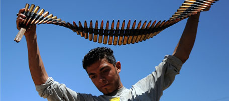 A Libyan rebel holds an anti-aircraft bullet belt inside a military training center in the eastern city of Benghazi on May 9, 2011 as Libyan regime forces laying siege to Misrata intensifyed their assault on the lifeline port and rebels warned they were running low on critical food and fuel supplies. AFP PHOTO/SAEED KHAN (Photo credit should read SAEED KHAN/AFP/Getty Images)