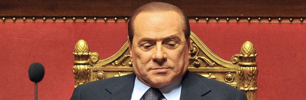 Italian Prime Minister Silvio Berlusconi adjusts his tie before addressing the Senate on June 21, 2011 in Rome. Silvio Berlusconi's government won a confidence vote on a bill in parliament, bringing temporary relief to the Italian premier after crushing defeats in local elections and a round of referendums. The government had turned a vote on a law for minor economic reforms into a show of confidence in the lower house, as Berlusconi prepared to reassure his supporters of his leadership in a speech to parliament later. AFP PHOTO / ALBERTO PIZZOLI (Photo credit should read ALBERTO PIZZOLI/AFP/Getty Images)