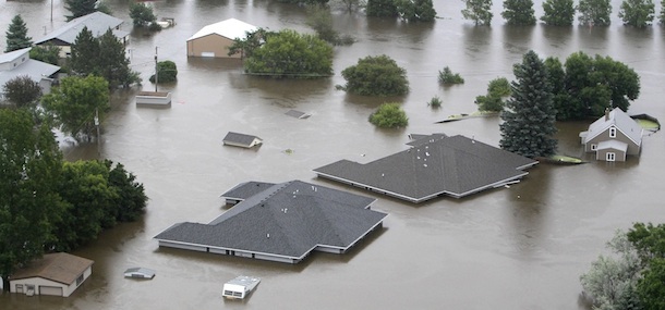 In this aerial photo flood waters from the Souris River continue to rise and consume neighborhoods In Burlington, N.D., Friday, June 24, 2011. (AP Photo/Charles Rex Arbogast)