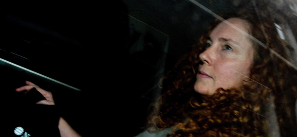 News International Chief Executive Rebekah Brooks is pictured behind her car's tinted windows as she leaves Rupert Murdoch's London home on July 12, 2011. Former British prime minister Gordon Brown accused Rupert Murdoch's media empire on Tuesday July 12, 2011, of using criminals to obtain his private documents, as lawmakers prepared to quiz police over phone hacking. AFP PHOTO / LEON NEAL (Photo credit should read LEON NEAL/AFP/Getty Images)