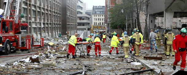 Paramedics and firefighters tend to victims of a bomb blast which took place outside the Norvegian Prime Minister's office in Oslo, on July 22, 2011. The powerful bomb blast rocked government and media buildings in Norway's capital, causing "deaths and injuries" and dealing heavy damage, police said. Police said a bomb was behind the explosion and Norwegian media reported that at least two people died. "A powerful explosion has taken place in the government quarter," Norwegian police said in a statement. AFP PHOTO/ SCANPIX NORWAY / Berit Roald ***NORWAY OUT*** (Photo credit should read BERIT ROALD/AFP/Getty Images)