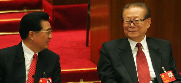 Chinese President Hu Jintao (L) chats with former president Jiang Zemin during the closing session of the 17th Communist Party Congress at the Great Hall of the People in Beijing 21 October 2007. China's ruling Communist Party ended its five-yearly Congress after amending its charter to include President Hu Jintao's economic model for the nation and endorsing leadership changes. AFP PHOTO/GOH CHAI HIN (Photo credit should read GOH CHAI HIN/AFP/Getty Images)