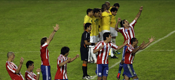 Paraguay's players , bottom, react in a penalty shootout against Brazil during a Copa America quarterfinal soccer match in La Plata, Argentina, Sunday, July 17, 2011. Paraguay won and advanced to semifinals.(AP Photo/Fernando Vergara)