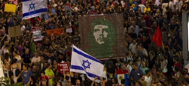 Israelis holds-up banners as they march in the centre of the coastal city of Tel Aviv on July 30, 2011, to protest against rising housing prices and social inequalities in the Jewish state. The demonstrators rallied in support of hundreds of people who have set up protest camps against the government's economic and social policies. AFP PHOTO/JACK GUEZ (Photo credit should read JACK GUEZ/AFP/Getty Images)