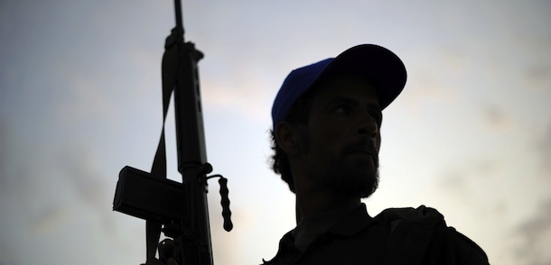 A Libyan rebel fighter mans a check point before the frontline at sunset on the outskirts of the Libyan eastern city Ajdabiya on May 19, 2011. US President Barack Obama said in his speech that Libya's Moamer Kadhafi will "inevitably" leave or be forced from power, as NATO declared it had significantly degraded the strongman's war machine. AFP PHOTO/ Saeed Khan (Photo credit should read SAEED KHAN/AFP/Getty Images)