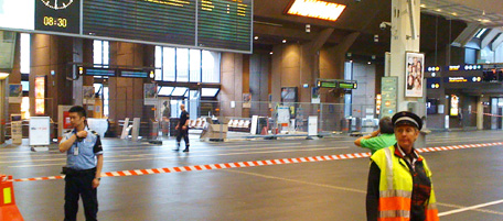 Security officials stand guard as parts of Oslo main railway station, Oslo S, were closed and evacuated early Wednesday morning, July 27, 2011 after a suitcase with no apparent owner was discovered on one of the platforms. Police and bomb experts are trying to assess the suitcase in situ. (AP Photo/Scanpix, Ole-Tommy Pedersen) NORWAY OUT