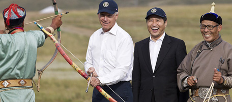 U.S. Vice President Joe Biden, center left, tries out an archery while Mongolian Prime Minister SÃ¼khbaatar Batbold, center right, look on as they visit a Mini-Nadam performance at the Yarmag Denj in Ulan Bator, Mongolia, Monday, Aug. 22, 2011. (AP Photo/Andy Wong)